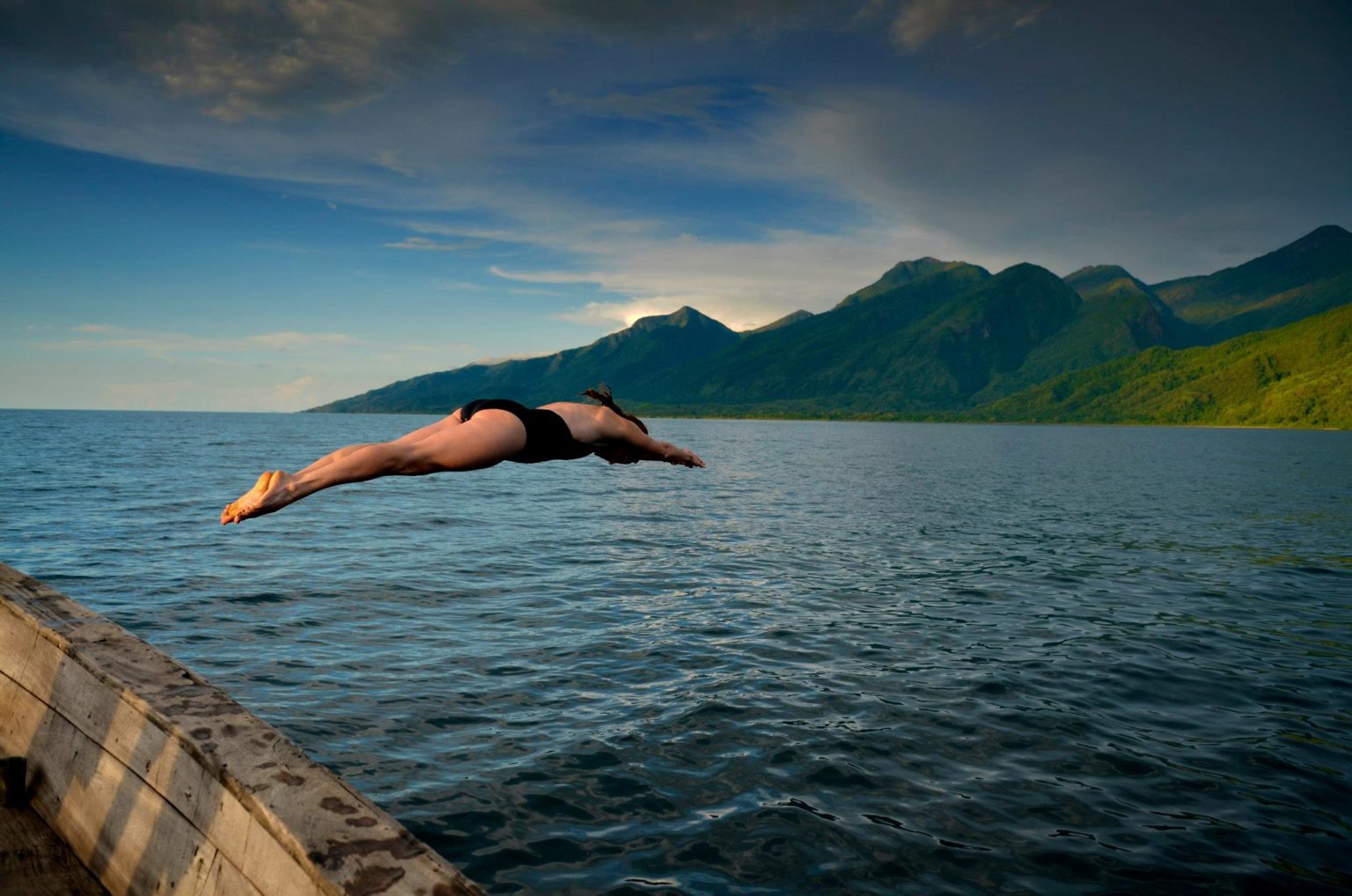 Kim diving into Lake Tanganyika with the Mahale Mountains in the background