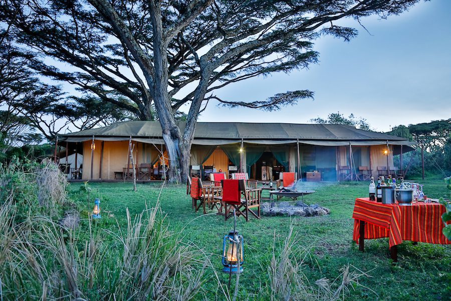 sundowners set up around the campfire in front of the lounge tent at Lemala Ngorongoro Crater Camp