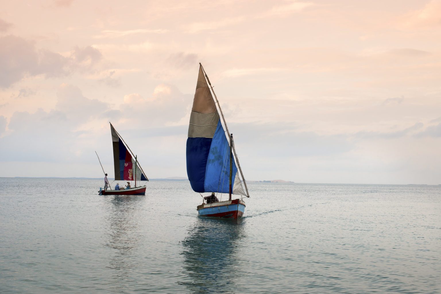 Mozambique dhows on water at sunset