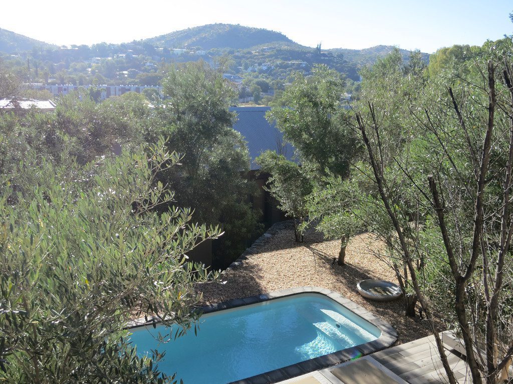View of city and mountains beyond Olive Exclusive Pool