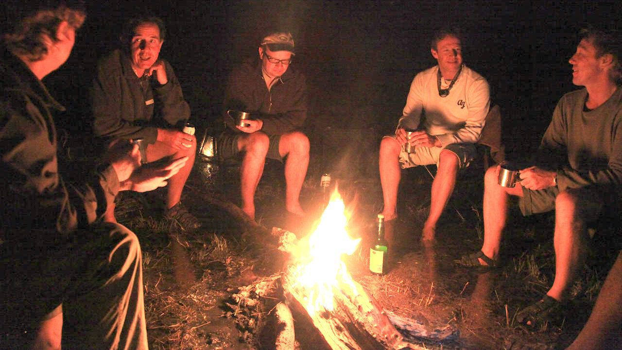 people gathered around a campfire at night
