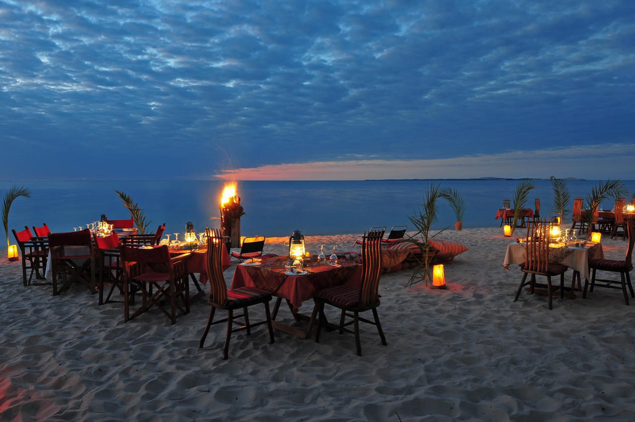 latern lit beach dinner at dusk