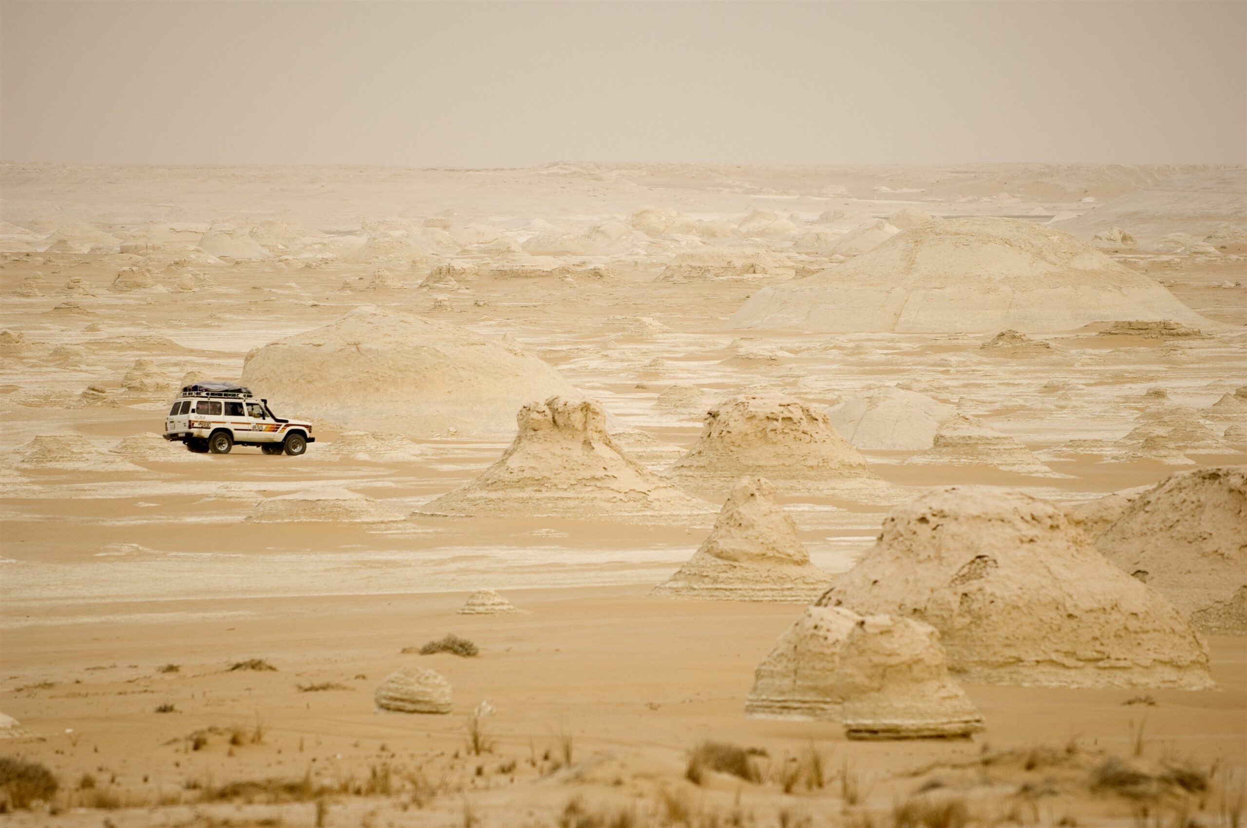 jeep driving through sand in desert on safari in Egypt