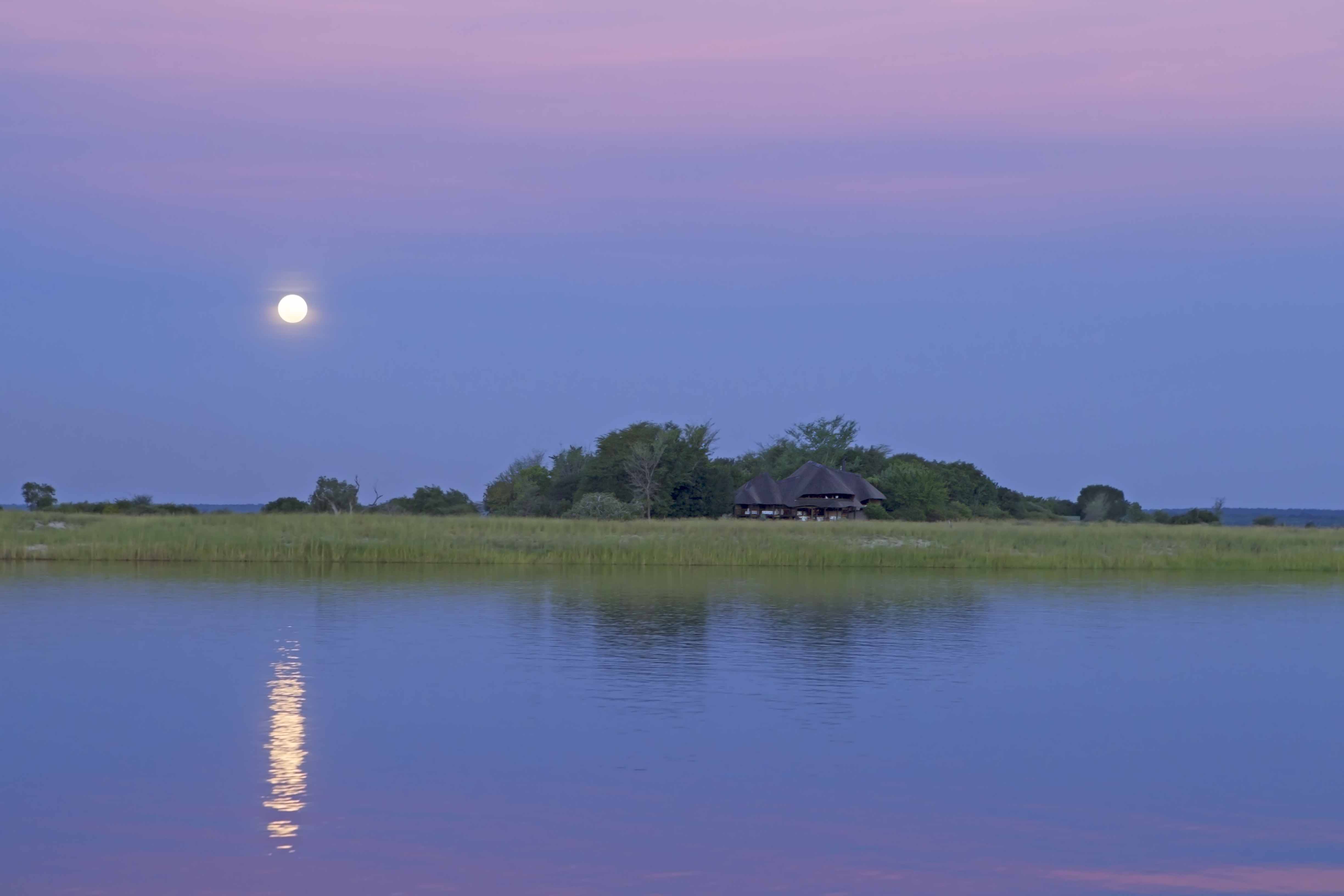 island at sunset with the moon overhead