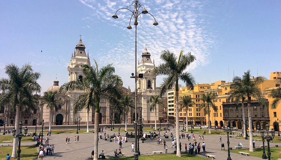 Old beautiful buildings and palm trees in a Havana plaza
