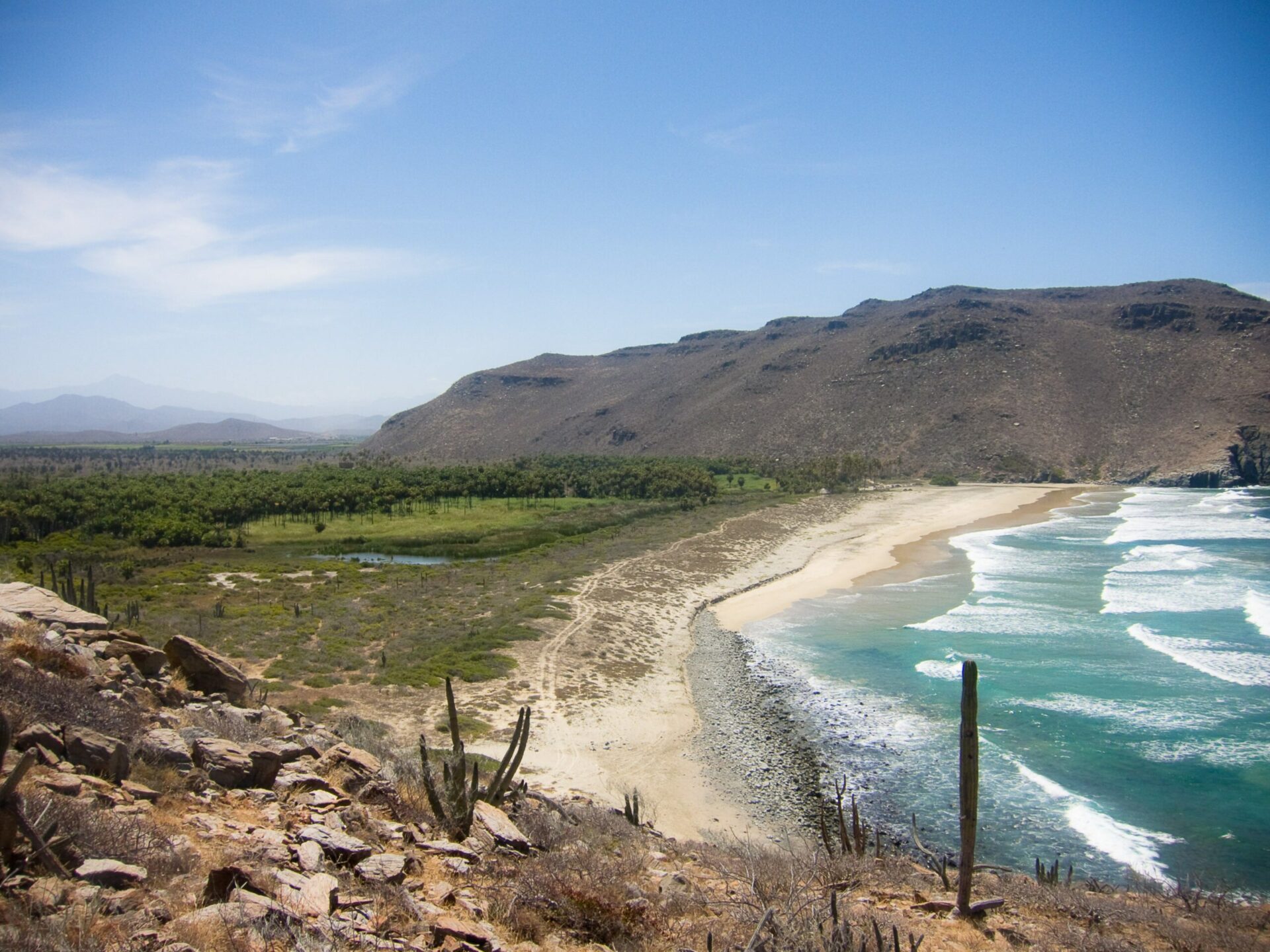 cliff view over ocean with beach and mountain on safari on Mexico holiday