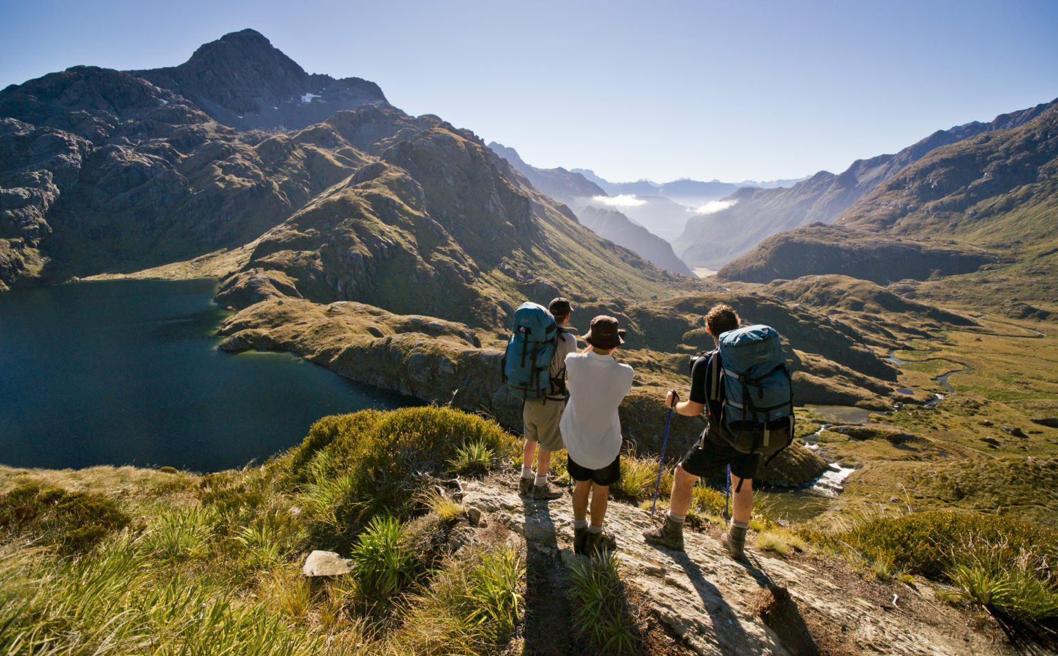 Hikers stop to enjoy the mountain views on the Routeburn Track.