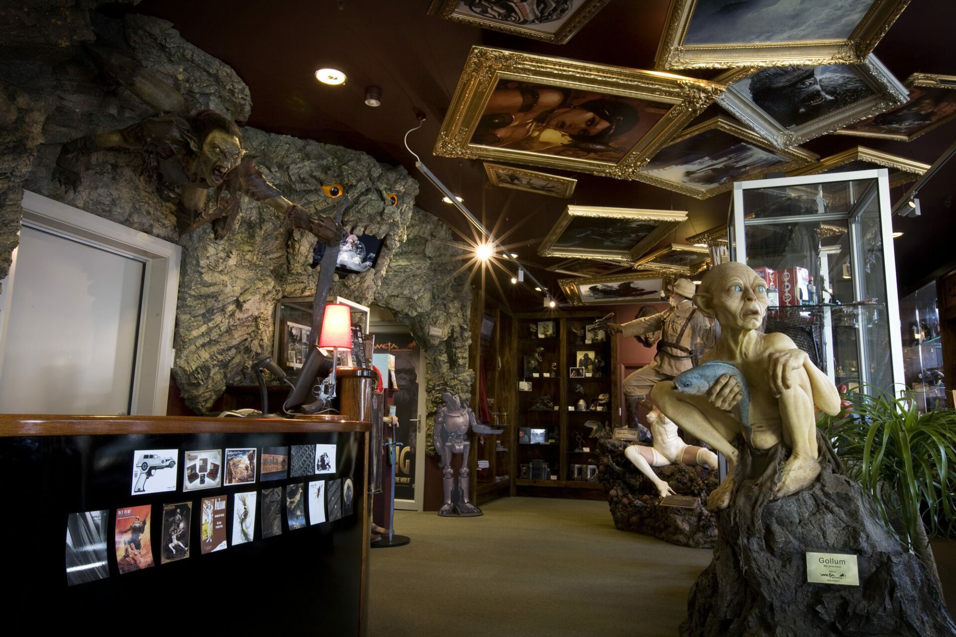 Inside the whacky Weta Cave Museum with picture frames on the ceiling.