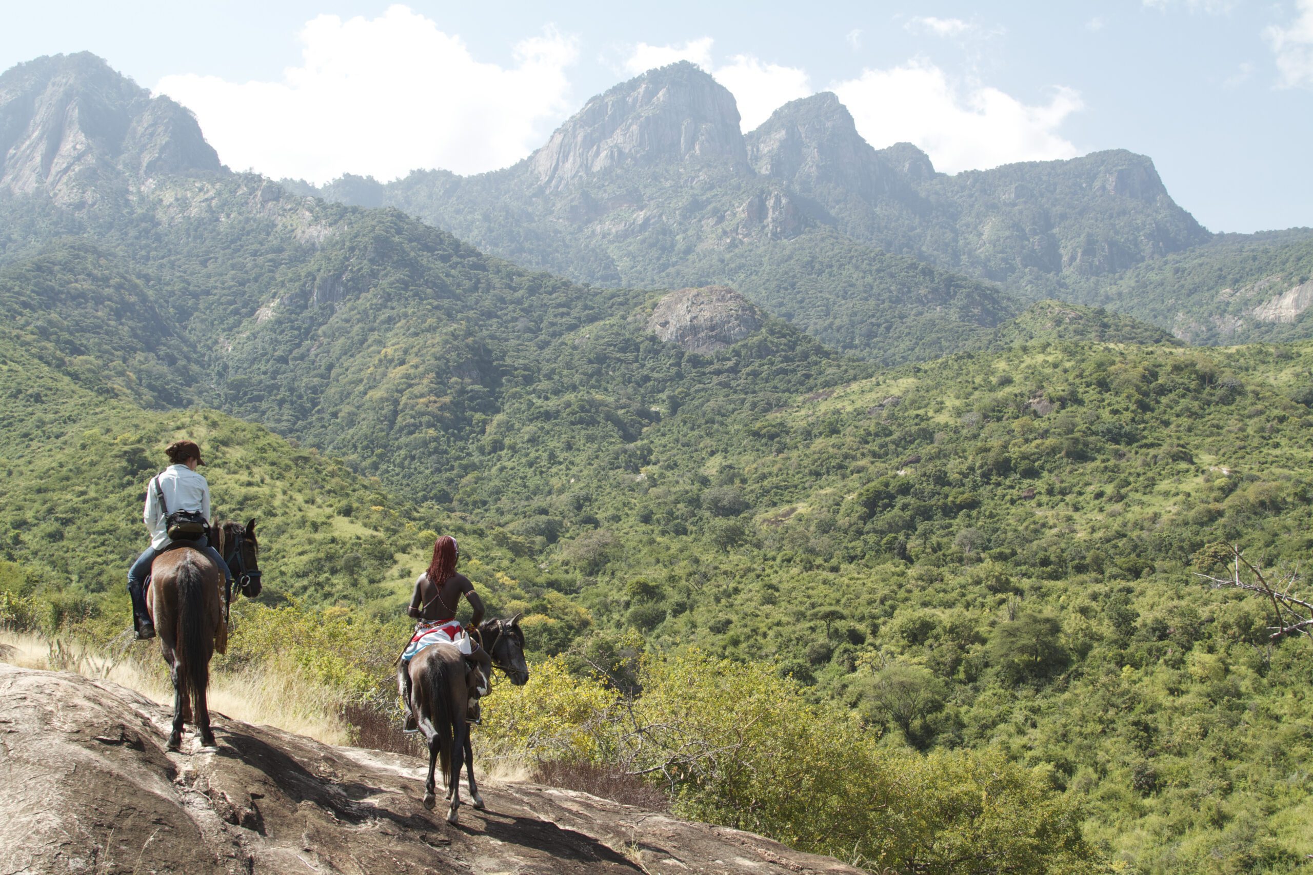 two people on bush ponies admiring the Mathews Range in northern Kenya