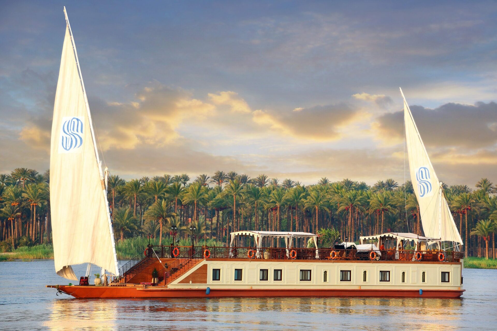 Cruise sailing down Nile of Egypt at Sunset on a boating safari