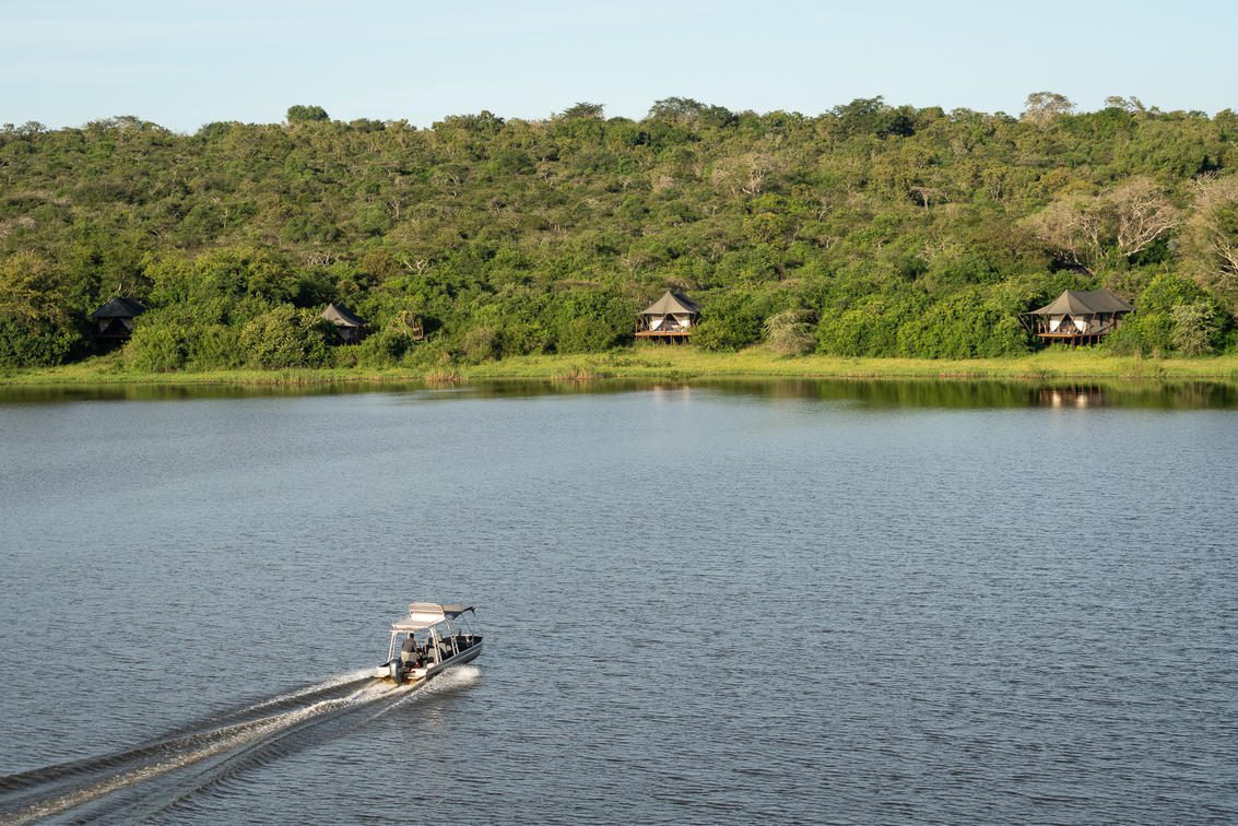 boat headed across Lake Rwanyakazinga towards Magashi Camp on the best Rwanda safari