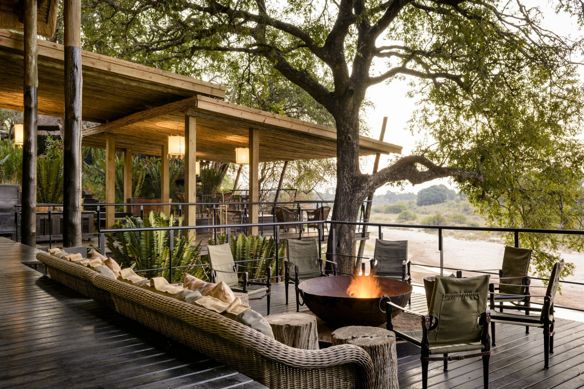 main lodge deck at Singita Ebony with a crackling fire overlooking the river in sabi sands on a South Africa safari
