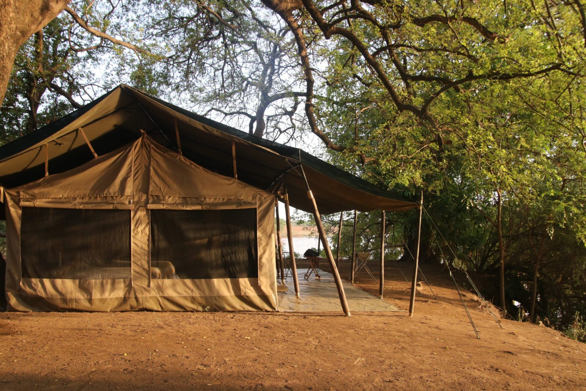Lale's Camp tent exterior among the shaded trees in the Omo Valley