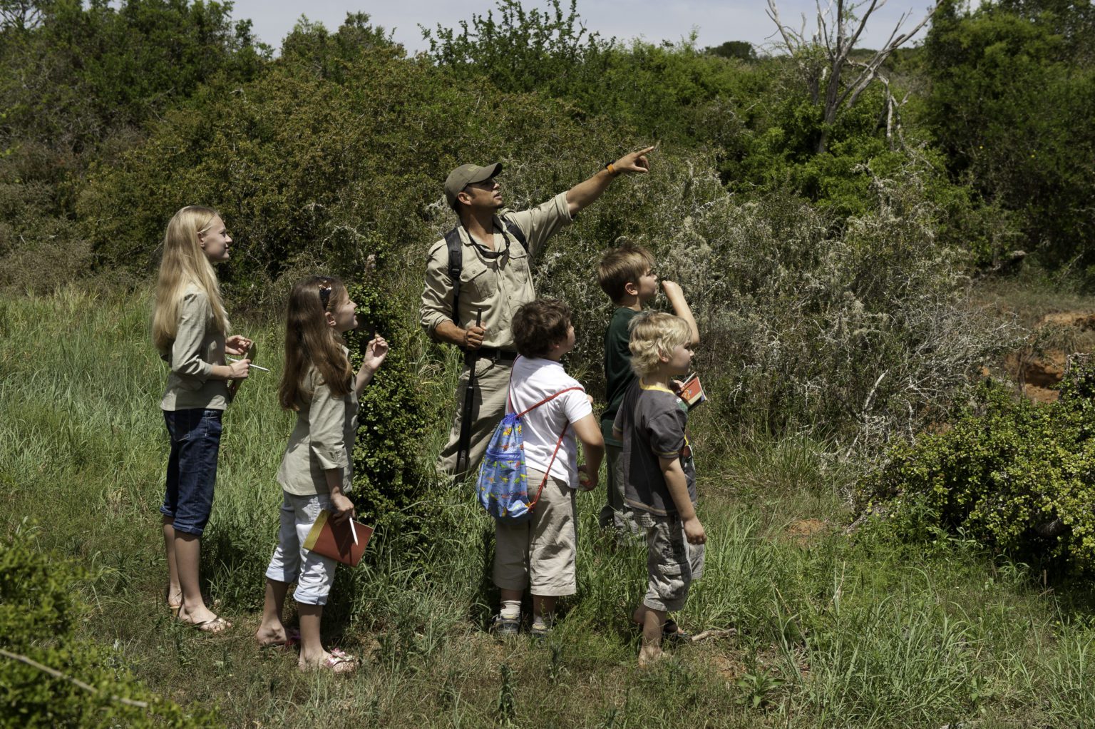 guide on a bush walk with kids at Kwandwe in South Africa