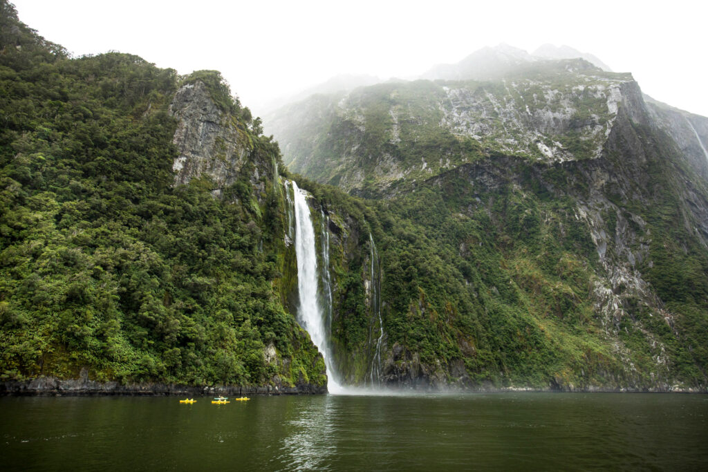 waterfall down green mountain milford track in new zealand