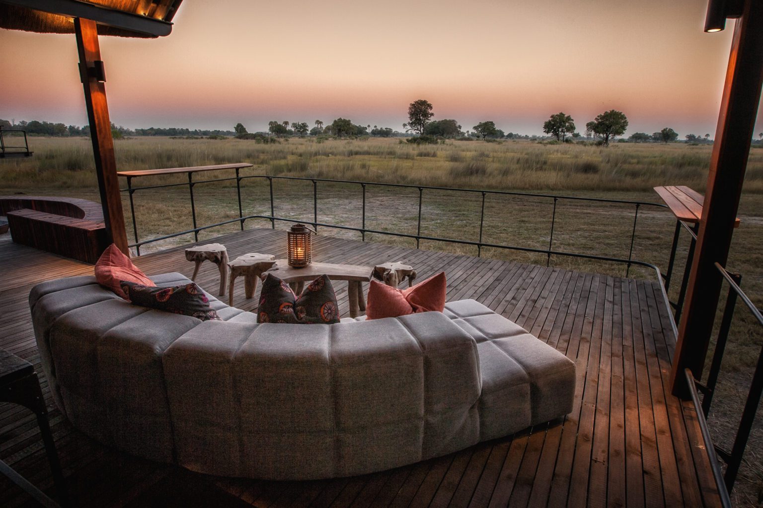 stay at Chitabe Camp deck lounge with view over the grassy plain on our off-grid Botswana safari