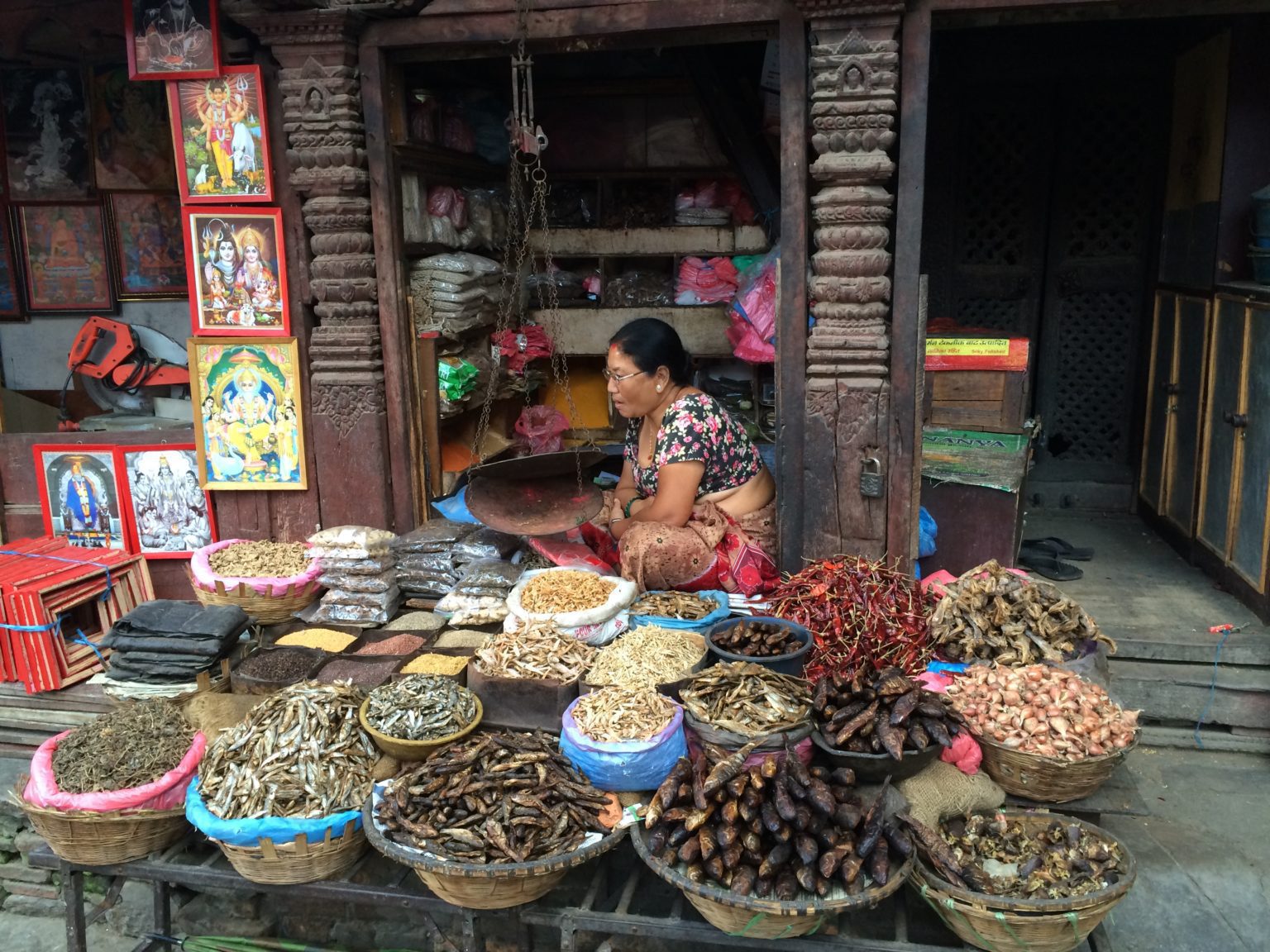 woman telling dried fish in her stall at a local market in Kathmandu