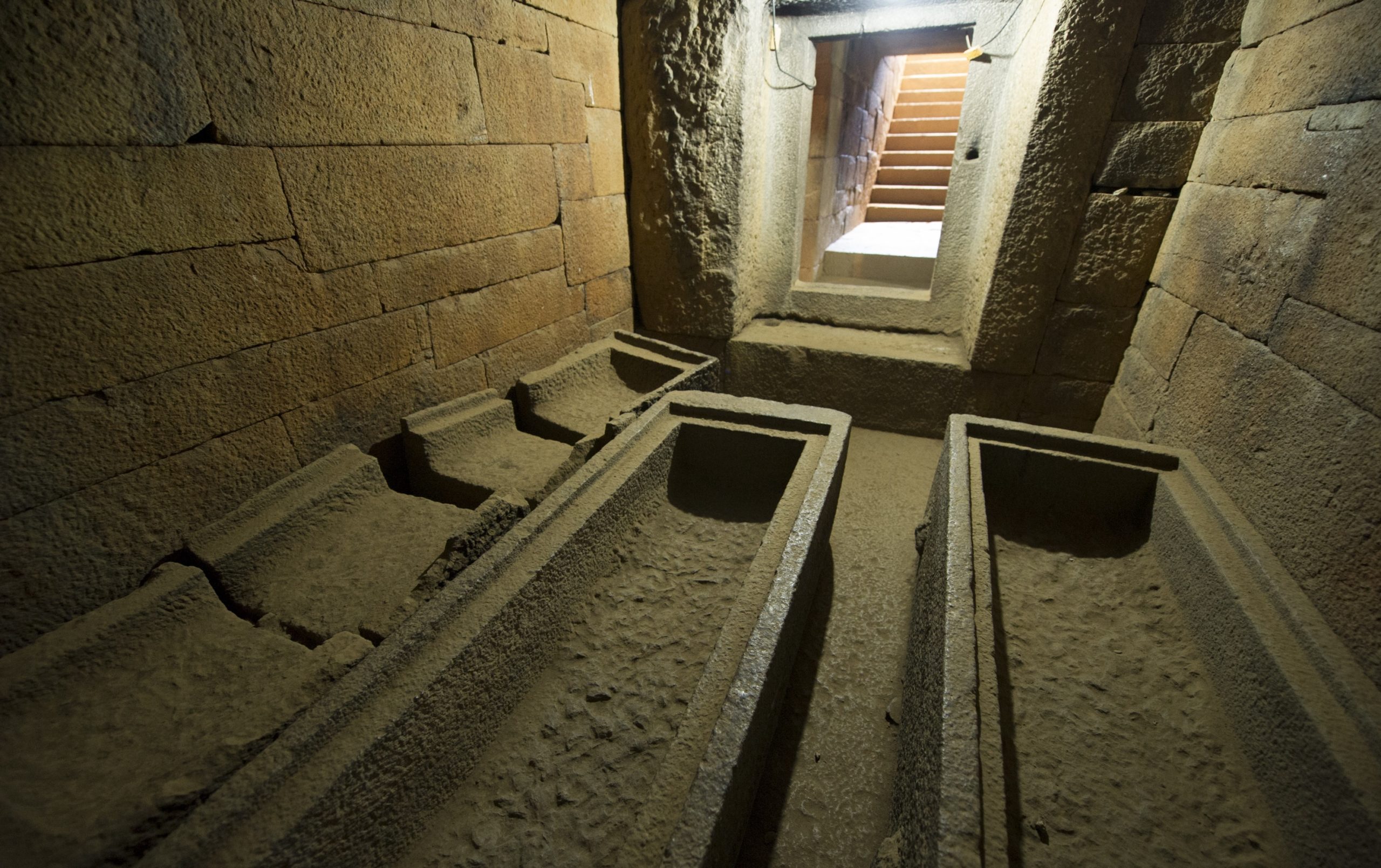 room with empty coffins in a tomb underground
