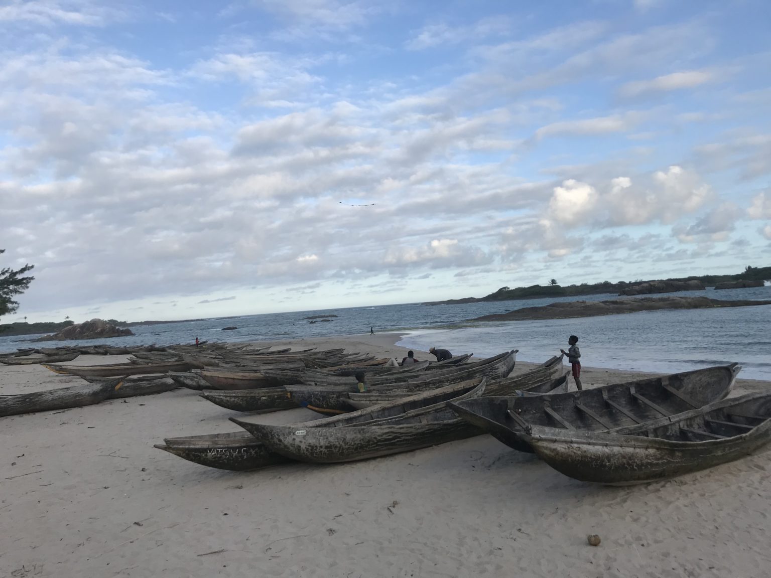 Madagascar, wooden canoes on beach on sunny day at Manifiafy Village