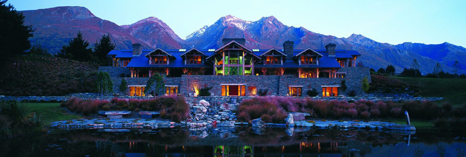 blanket bay lodge in glenorchy with lake wakatipu in front and the mountains behind
