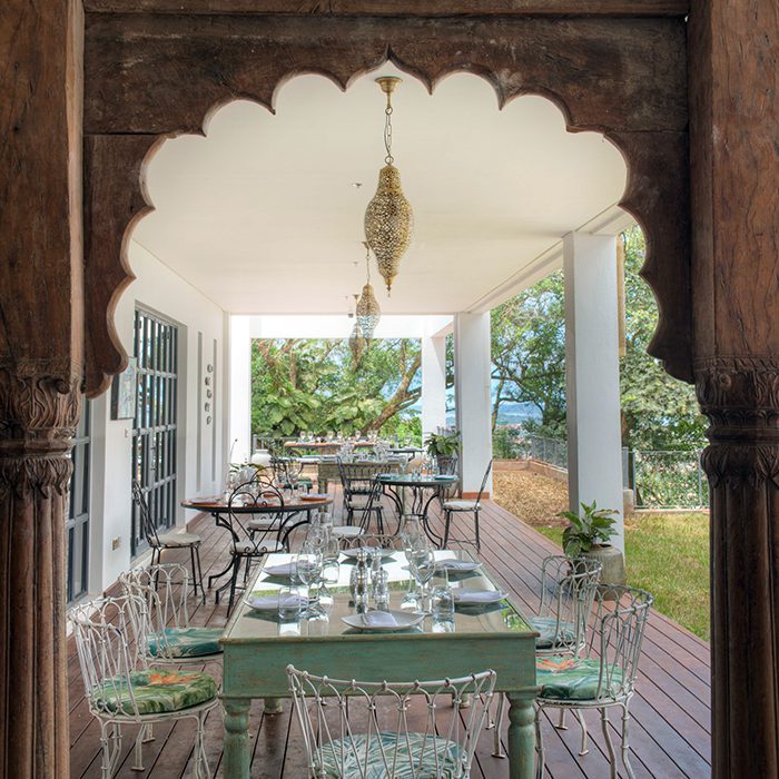 looking through an arch to a dining table on a patio