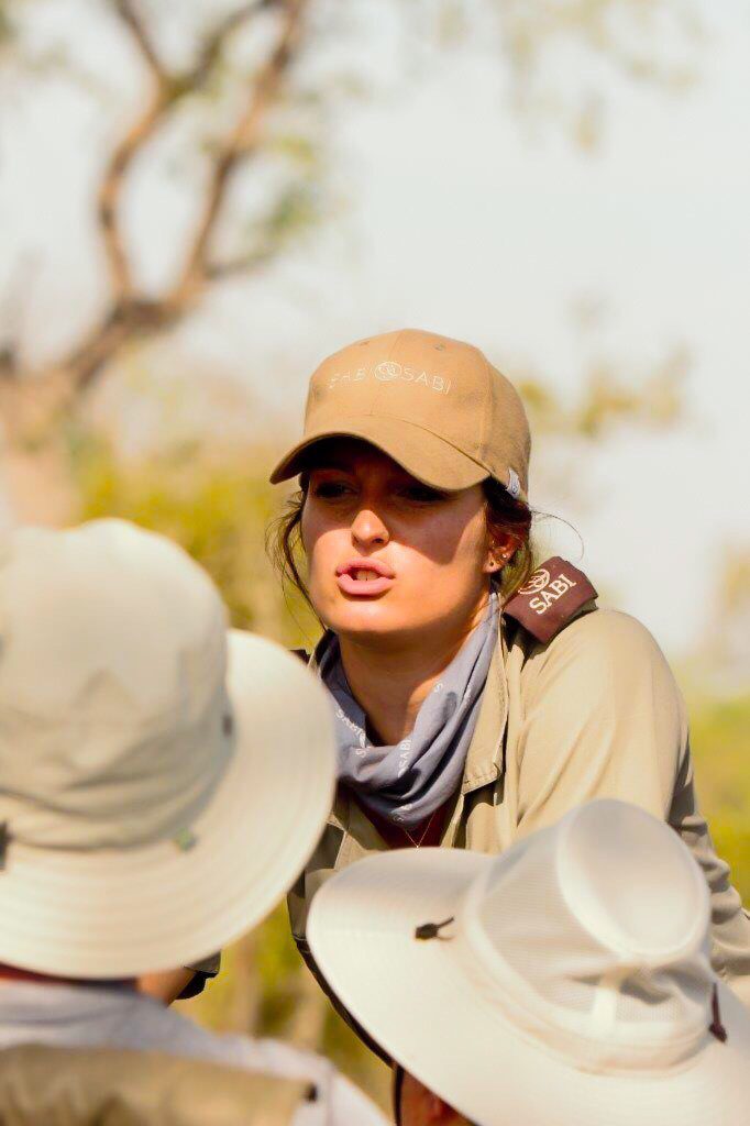 guide Ally Ross talking to two people on a game drive