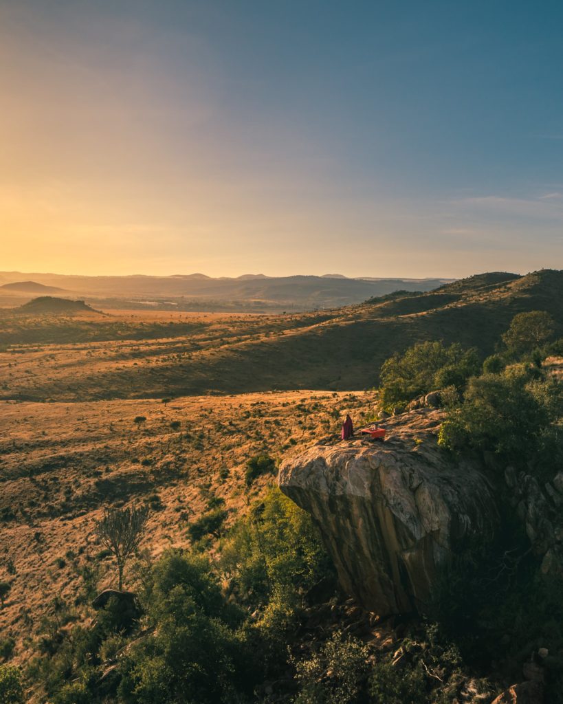 Safari in Kenya: A Chance for Three Generations to Reconnect and Explore, People on Top of a Rock in Borana Conservancy Watching the Sunset