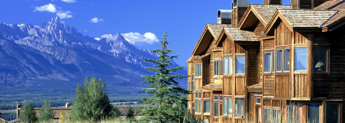 Wooden condos in front of Grand Teton Mountains