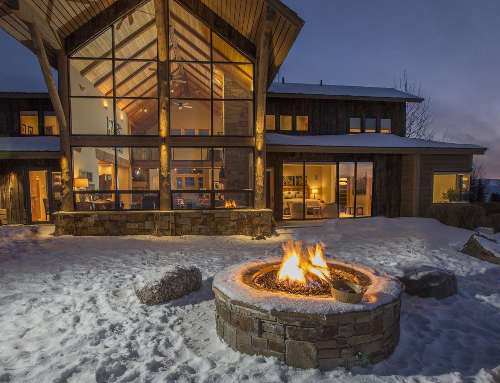 Firepit outside of a snowy private villa in Colorado