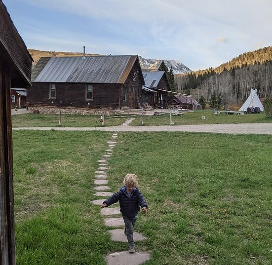 Little boy running through campground