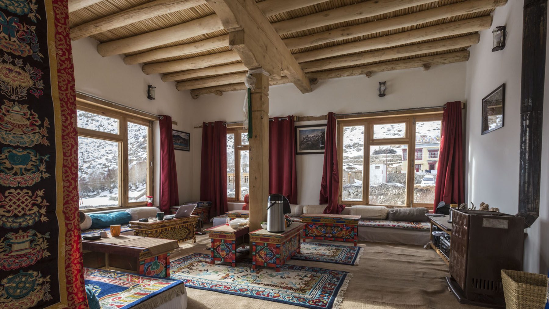 main areas of Snow Leopard Lodge showing exposed beams and warm interiors