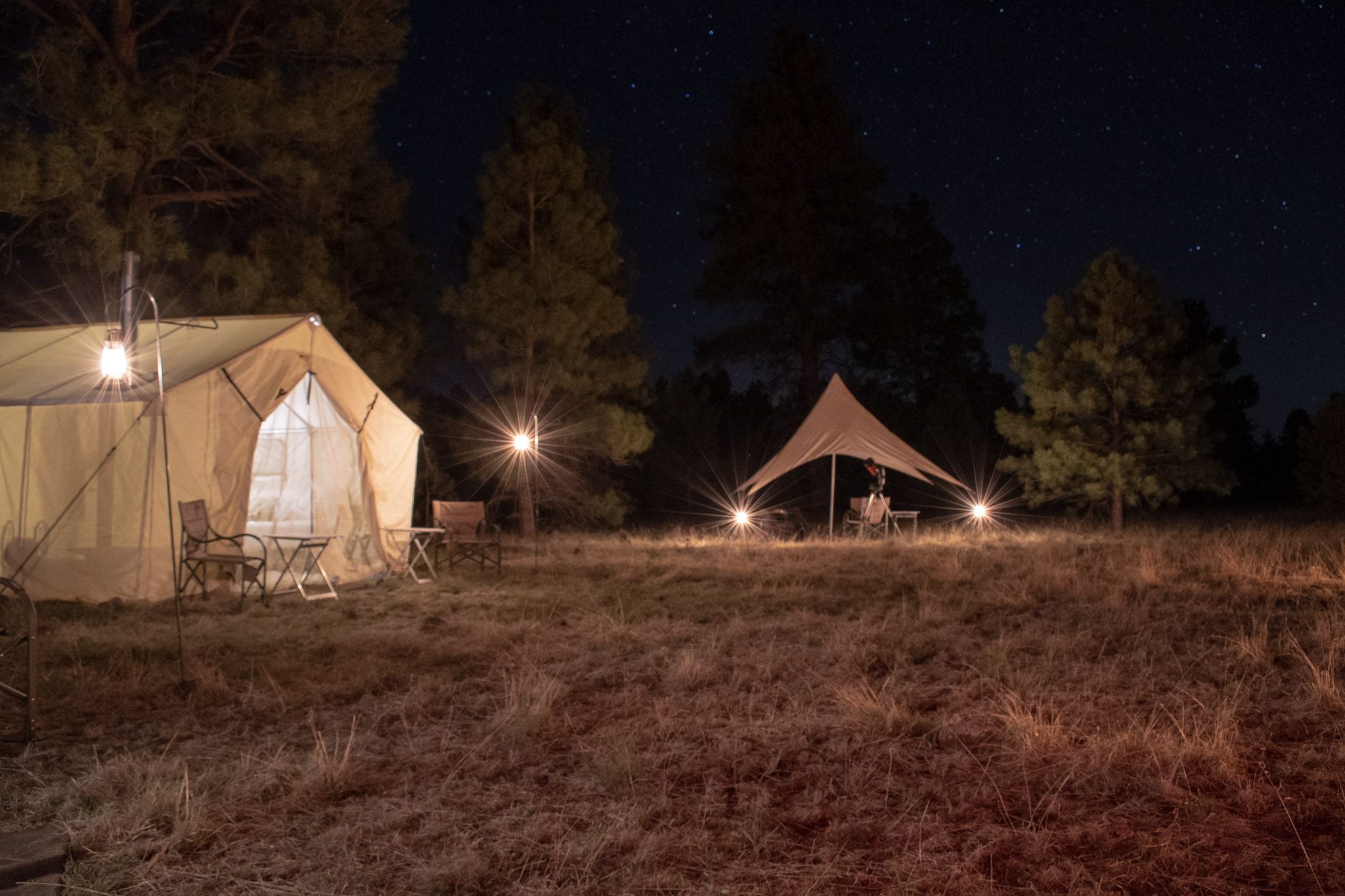 white tents lit by lantern light at night