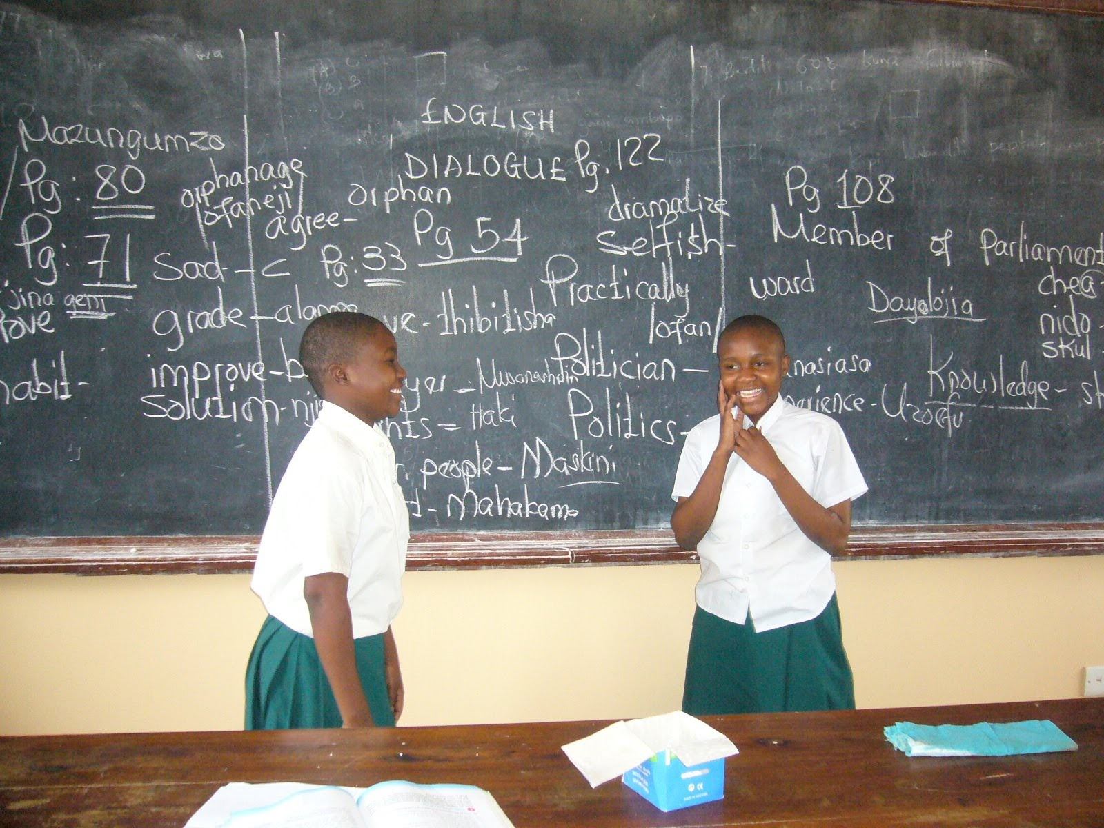 Leila and Sauda doing the English Dialogue in front of their entire English class at SEGA school for girls in Tanzania. Image courtesy of Nurturing Minds.