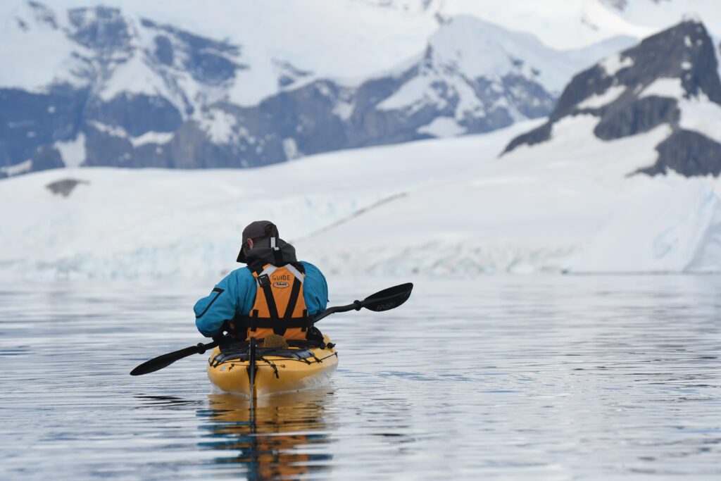 Kayaking in Antarctica wearing dry suits to protect guests from all the elements while on the Southern Ocean. 