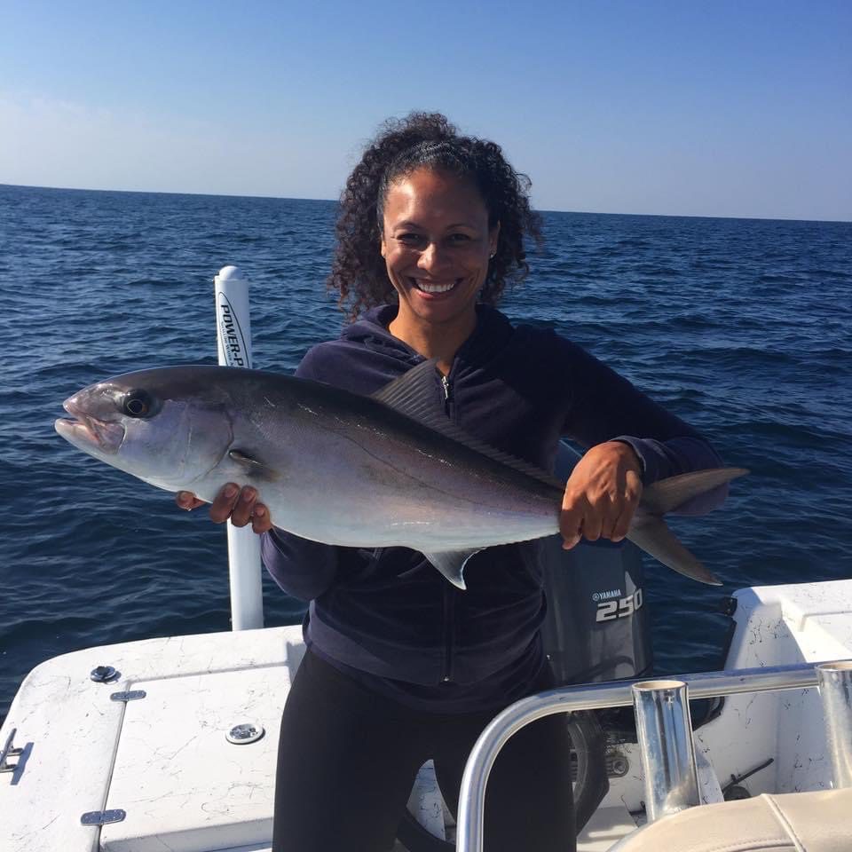 Woman holding fish on a boat in the Gulf of Mexico