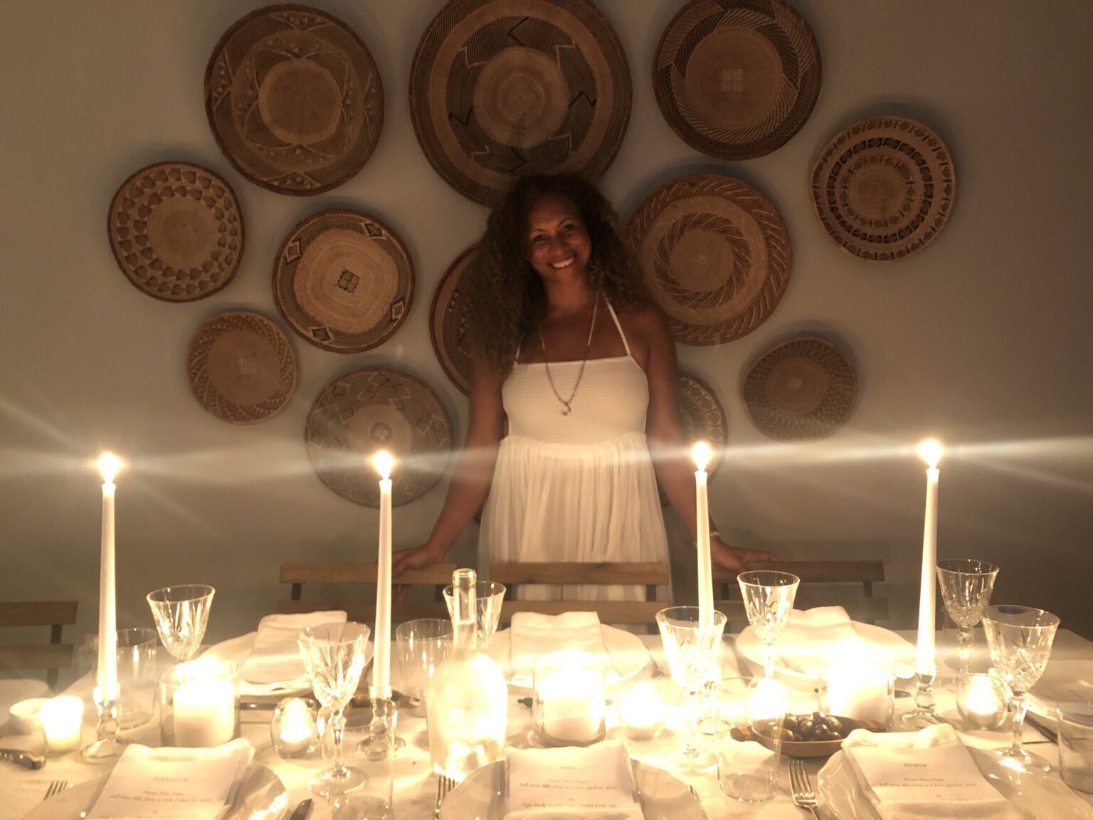 a woman standing in front of a table with plates on it.