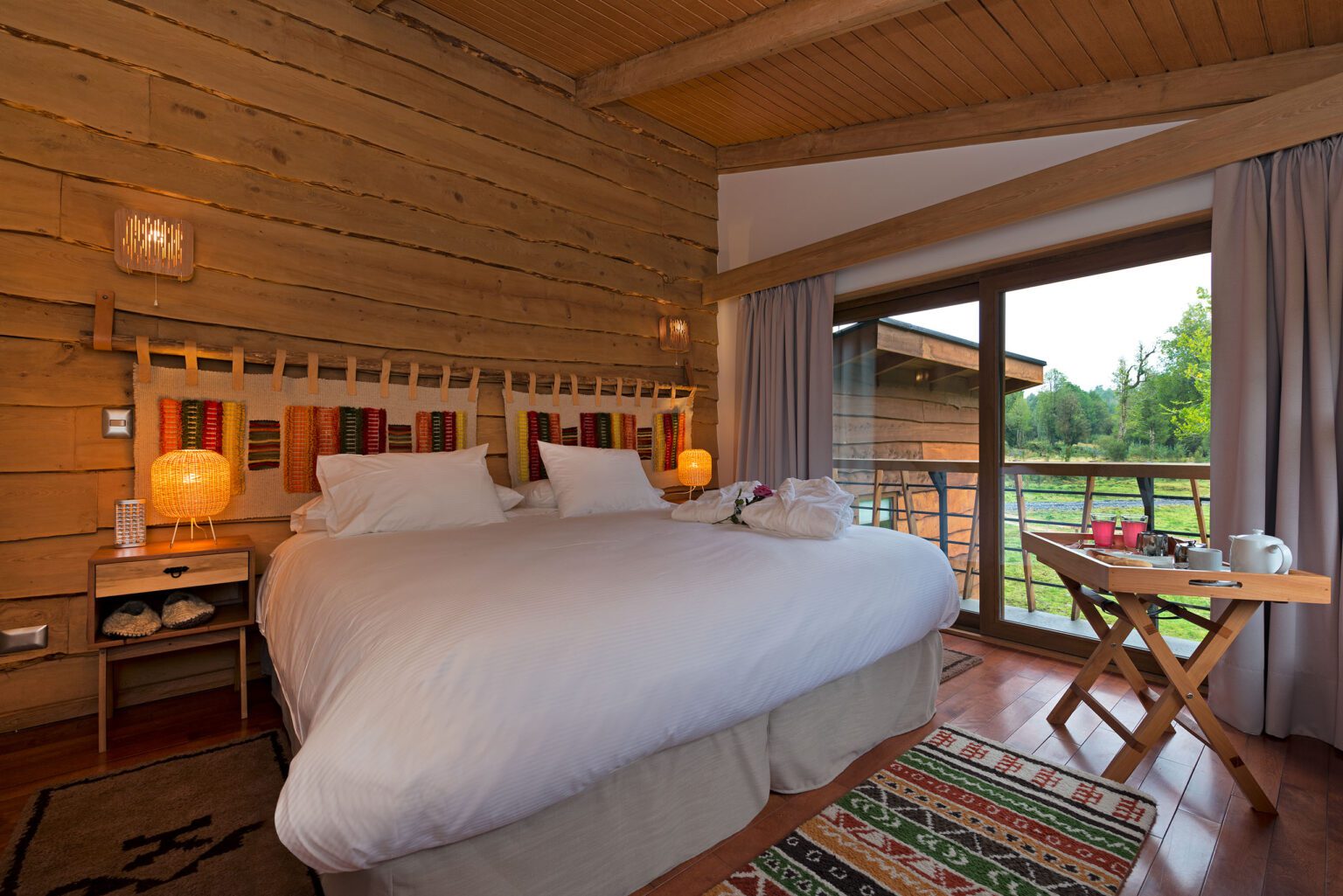 a bedroom with a large bed and wooden walls.