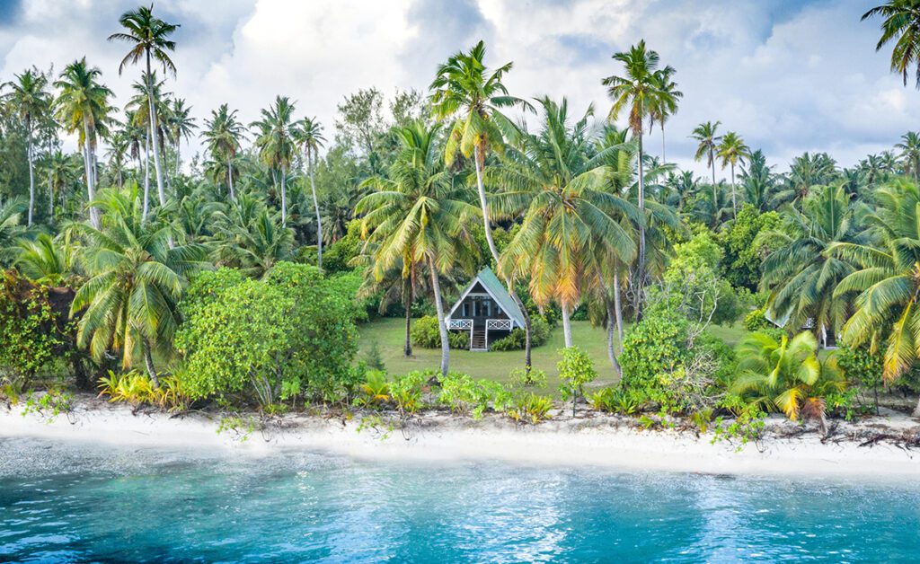Ocean view of Alphonse Island Resort located on the beach of Seychelles surrounded by lush forest vegetation 