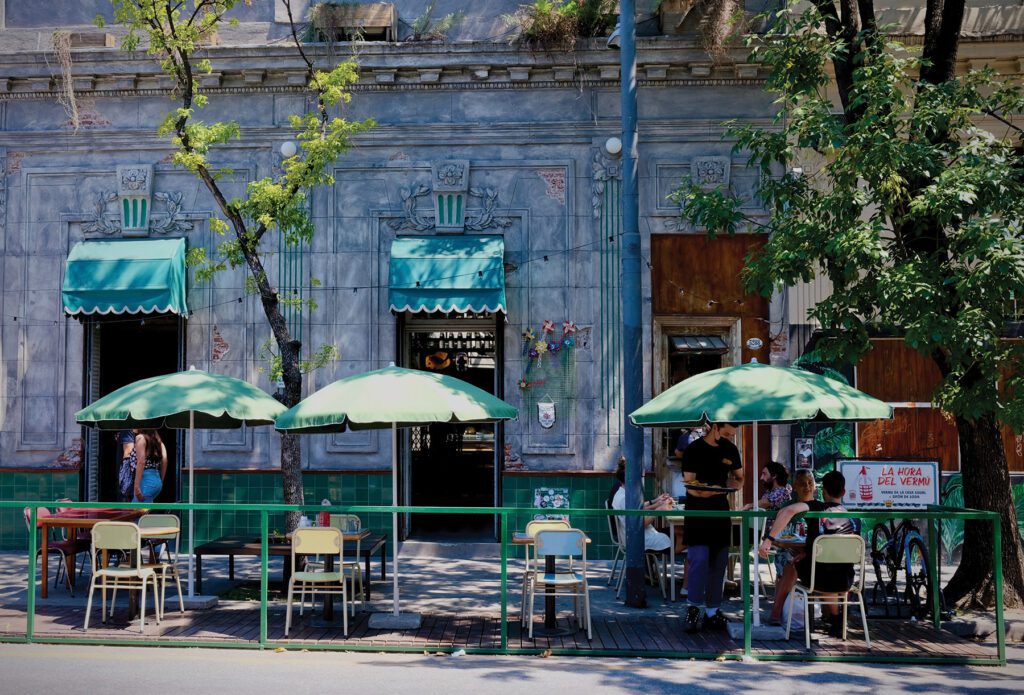 Tables and chairs setup in front of cafe shop in the city of Buenos Aires.
