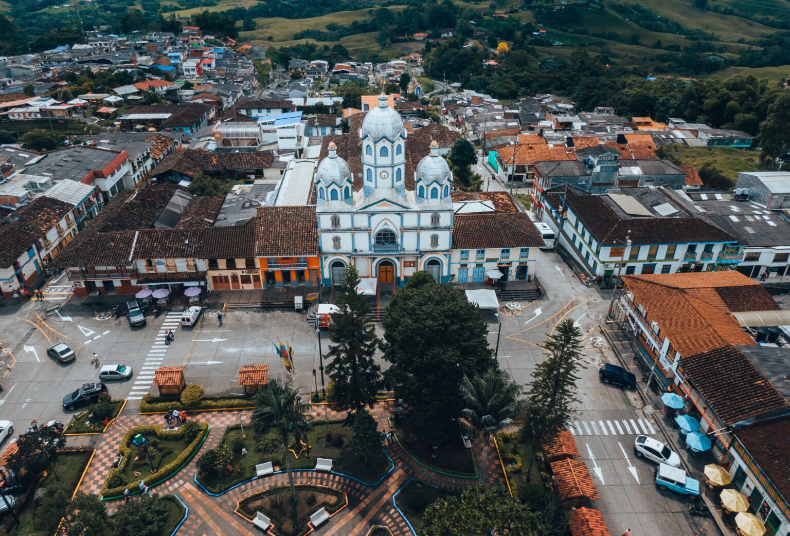 an aerial view of a city with a church.