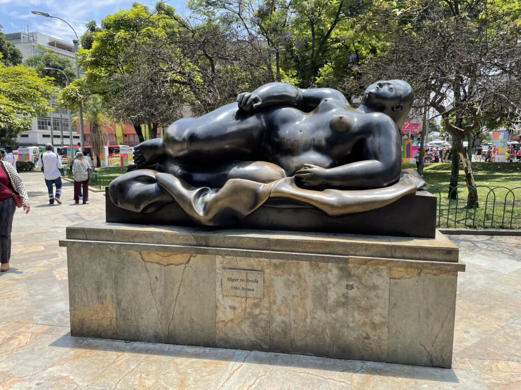 Tight shot of the sculpture Mujer Reclinada by artist Farnando Botero in Plaza Botero