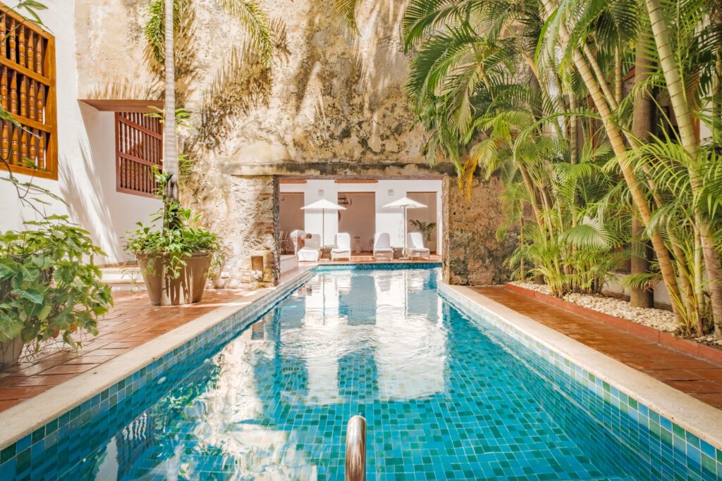 Casa San Agustin’s unique L-shaped pool is built around a 300-year-old aqueduct. Image courtesy of Casa San Agustin