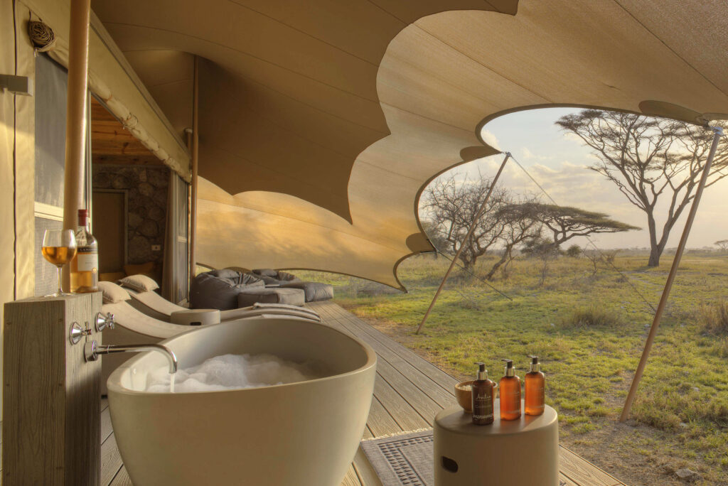 It doesn’t get more luxurious than the barefoot luxury of Namiri Plains Camp—tents complete with baths, sunbeds, and unbeatable views. Image courtesy of Asilia Africa
