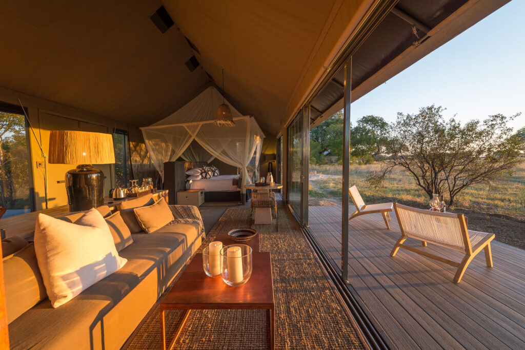 Shaded by leadwood trees, Linkwasha’s tented suites offer views of the camp’s water hole.  