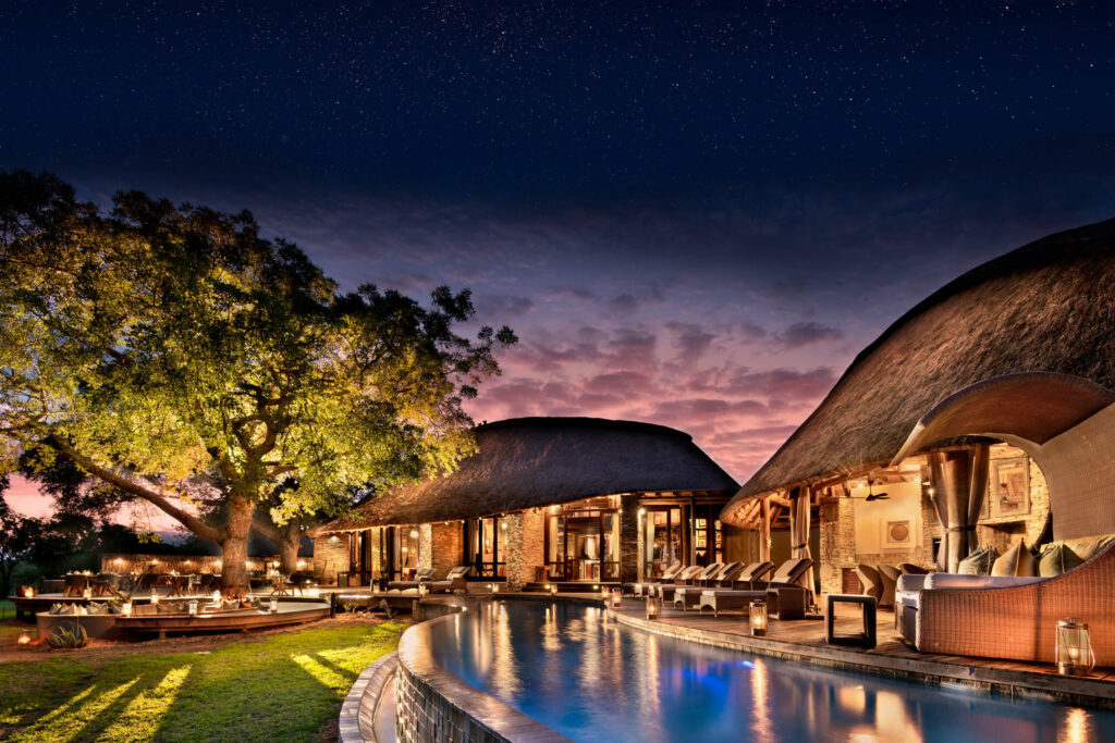 Makanyi Private Game Lodge pool and deck area lit up at night time in the Timbavati Reserve
