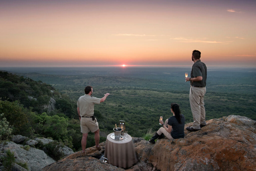 Sundowners overlooking the bush as the sun sets at Phinda Vlei Lodge, Phinda Private Game