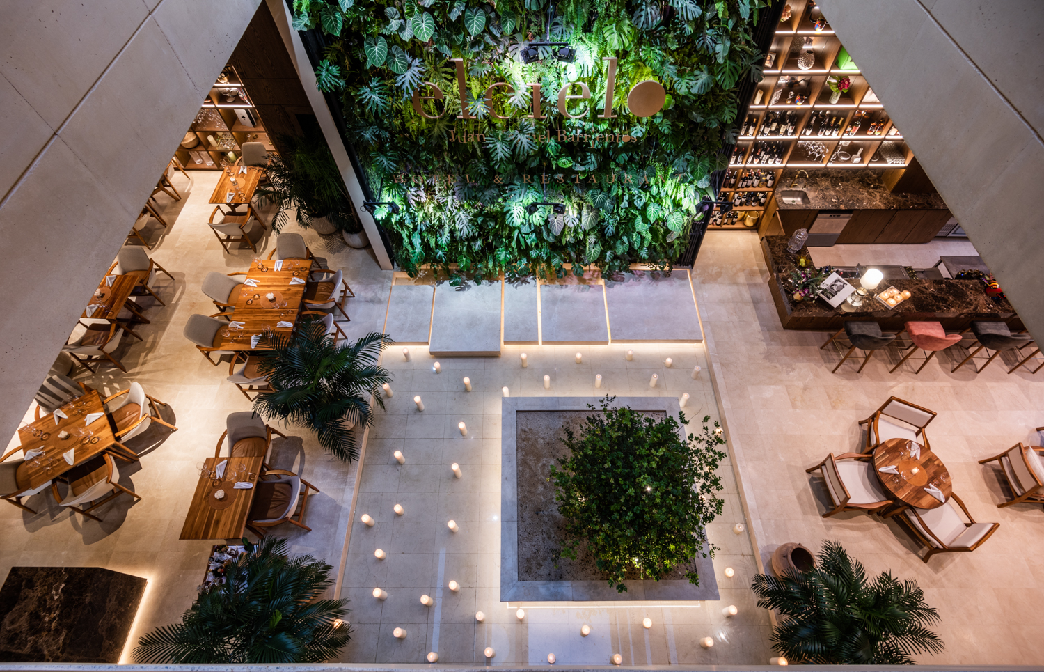 Hotel lobby from above with green wall and candles