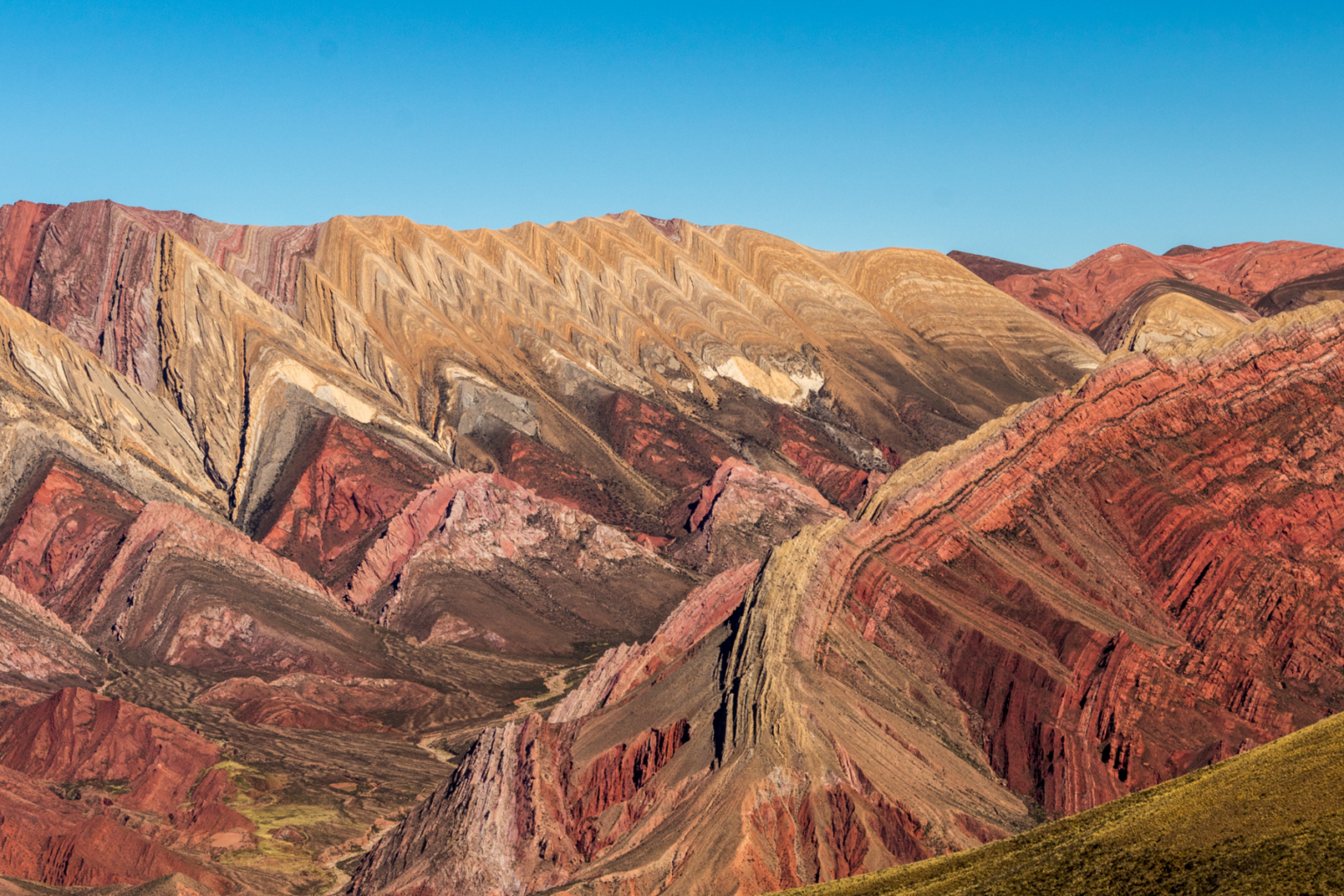 Colorful mountains against bright blue sky