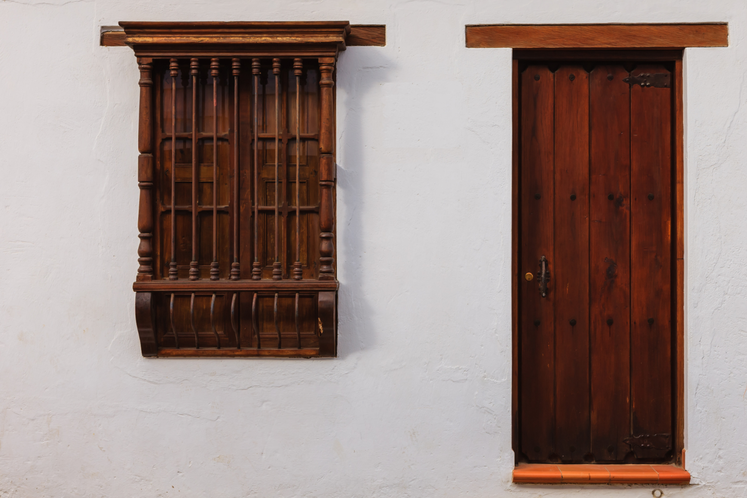 Wooden window and door on white wall