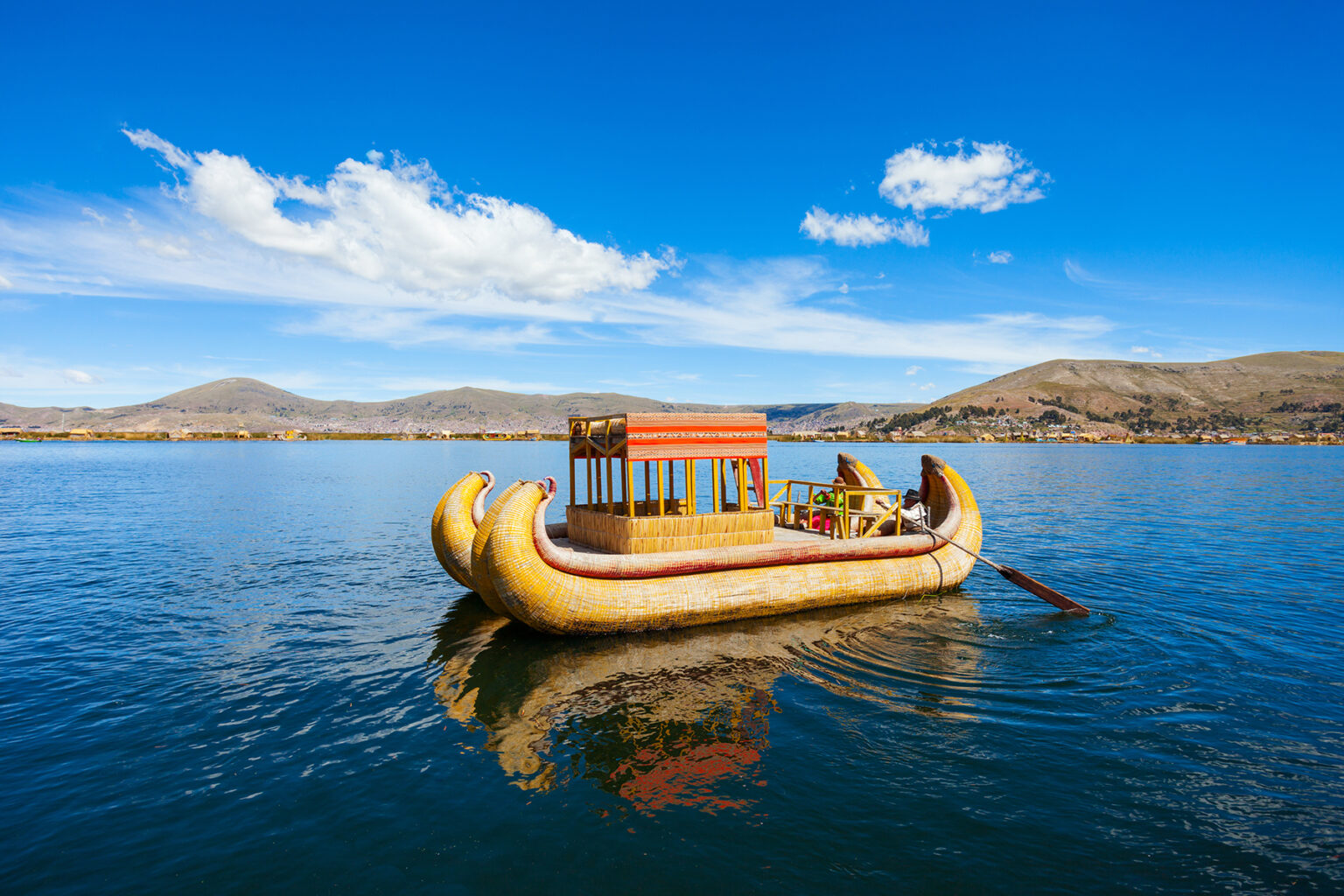 Traditional boat on a lake with blue sky
